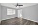 Gray bedroom with new floors, ceiling fan, and an ensuite bathroom at 7039 N 15Th St, Phoenix, AZ 85020