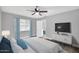 Cozy bedroom with gray walls, new floors, and a television at 7039 N 15Th St, Phoenix, AZ 85020