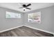 Gray bedroom featuring new floors and a ceiling fan with windows at 7039 N 15Th St, Phoenix, AZ 85020