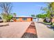 Lovely single-story brick home featuring desert landscaping, a driveway, and an attached garage at 7039 N 15Th St, Phoenix, AZ 85020