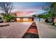 Charming brick home with a desert-landscaped front yard and a welcoming driveway at sunset at 7039 N 15Th St, Phoenix, AZ 85020