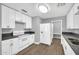 White kitchen features updated appliances, countertops, and cabinet hardware at 7039 N 15Th St, Phoenix, AZ 85020