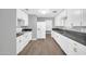 Modern kitchen featuring sleek white cabinets, gray countertops, and updated appliances at 7039 N 15Th St, Phoenix, AZ 85020