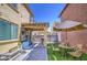 Inviting backyard featuring a covered patio, outdoor seating, manicured lawn, and patio dining area at 7412 E Flower Ave, Mesa, AZ 85208