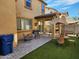 This backyard has pavers, green turf, seating, a grill and shade provided by a large umbrella at 7412 E Flower Ave, Mesa, AZ 85208
