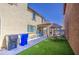 Landscaped backyard featuring a covered patio, outdoor seating, manicured grass, and a dining set at 7412 E Flower Ave, Mesa, AZ 85208