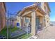Outdoor patio with seating, a dining set, and artificial grass, nestled between two homes at 7412 E Flower Ave, Mesa, AZ 85208
