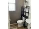 Powder room features a pedestal sink, modern fixtures, floating shelves, and is decorated with neutral tones at 7412 E Flower Ave, Mesa, AZ 85208