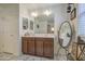 Well-lit bathroom featuring dual sinks, vanity with storage, and a large mirror for a bright and open feel at 7412 E Flower Ave, Mesa, AZ 85208