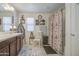 Bright bathroom featuring a neutral color scheme, decorative accents, and a shower with patterned curtain at 7412 E Flower Ave, Mesa, AZ 85208