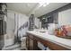 Bathroom features decorative shelving with mounted plants, a large decorative mirror, and modern fixtures at 7412 E Flower Ave, Mesa, AZ 85208