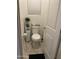 Cozy half-bathroom featuring a toilet, storage cabinet, and tile flooring offering a convenient and functional space at 7412 E Flower Ave, Mesa, AZ 85208
