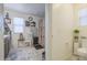 Bright bathroom featuring a neutral color scheme, decorative accents, and a shower with patterned curtain at 7412 E Flower Ave, Mesa, AZ 85208