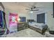 Bedroom features rustic wood furniture, cozy bedding, and a plush rug on neutral carpeting at 7412 E Flower Ave, Mesa, AZ 85208