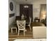 A dining room with an ornate chandelier, wood floors, stylish decor, and neutral decor creates a warm atmosphere at 7412 E Flower Ave, Mesa, AZ 85208