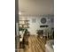 A dining room featuring wood floors, stylish decor, open shelving, and lots of natural light at 7412 E Flower Ave, Mesa, AZ 85208