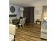 An inviting dining room with wood floors, modern lighting, and neutral decor creates a warm and stylish atmosphere at 7412 E Flower Ave, Mesa, AZ 85208