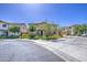 Two-story home with a well-maintained yard, mature trees, and a sidewalk at 7412 E Flower Ave, Mesa, AZ 85208