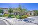 Charming two-story home featuring lush green landscaping, mature trees, and a welcoming entrance at 7412 E Flower Ave, Mesa, AZ 85208