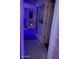 Hallway with blue lighting featuring carpet, mirrors, decor, and an open doorway creating an interesting and inviting space at 7412 E Flower Ave, Mesa, AZ 85208