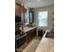 Kitchen area featuring dark brown cabinetry, stainless steel appliances, ample countertop space, and natural lighting at 7412 E Flower Ave, Mesa, AZ 85208