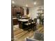 Kitchen featuring an island with seating, stainless appliances, dark cabinetry, and a stylish backsplash at 7412 E Flower Ave, Mesa, AZ 85208