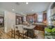 Well-appointed kitchen featuring a spacious island, stainless steel appliances, and dark wood cabinets at 7412 E Flower Ave, Mesa, AZ 85208