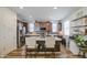 Well-appointed kitchen featuring a spacious island, stainless steel appliances, and dark wood cabinets at 7412 E Flower Ave, Mesa, AZ 85208