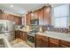 Modern kitchen with stainless steel appliances, granite countertops, and wood cabinets, perfect for cooking and entertaining at 7412 E Flower Ave, Mesa, AZ 85208