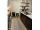 Kitchen showcasing stainless steel appliances, granite counters, a stylish faucet, and custom floating shelves at 7412 E Flower Ave, Mesa, AZ 85208