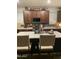 Kitchen showcasing an island with seating, stainless appliances, dark cabinetry, and a stylish backsplash at 7412 E Flower Ave, Mesa, AZ 85208