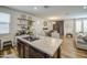 Island in modern kitchen with stainless sink, granite countertops, view into dining and living room at 7412 E Flower Ave, Mesa, AZ 85208