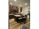 Kitchen featuring an island with seating, stainless appliances, dark cabinetry, and a stylish backsplash at 7412 E Flower Ave, Mesa, AZ 85208