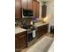Kitchen features stainless steel appliances, granite counters, a stylish backsplash, and a gas stove at 7412 E Flower Ave, Mesa, AZ 85208