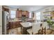Well-appointed kitchen featuring a spacious island, stainless steel appliances, and dark wood cabinets at 7412 E Flower Ave, Mesa, AZ 85208