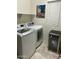 This laundry room comes equipped with a washer and dryer, as well as a beverage fridge at 7412 E Flower Ave, Mesa, AZ 85208