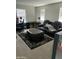 This living room includes an ottoman, a couch, and a desk with natural light from three windows at 7412 E Flower Ave, Mesa, AZ 85208
