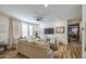Cozy living room area features a ceiling fan, TV, and lots of seating for guests at 7412 E Flower Ave, Mesa, AZ 85208