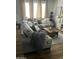 Comfortable living room featuring wood floors, grey furnishings, and neutral decor at 7412 E Flower Ave, Mesa, AZ 85208
