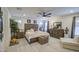 Cozy main bedroom with a rustic wooden bed frame, plush bedding, and an en-suite bathroom at 7412 E Flower Ave, Mesa, AZ 85208