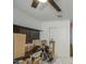 Bright office space featuring a ceiling fan, closet, and shelving for organization and storage at 7412 E Flower Ave, Mesa, AZ 85208