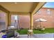 Inviting covered patio with a grill, and manicured backyard with an outdoor dining area and seating at 7412 E Flower Ave, Mesa, AZ 85208
