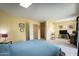 Spacious bedroom with a large bed, skylight, and ample space for a desk and seating area at 7755 E Thomas Rd # 17, Scottsdale, AZ 85251