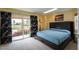 Bedroom with a large bed, floral curtains, and a sliding glass door to the balcony with a golf course view at 7755 E Thomas Rd # 17, Scottsdale, AZ 85251