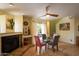 Cozy dining area with a fireplace and a glass table that seats four, accented with colorful chairs at 7755 E Thomas Rd # 17, Scottsdale, AZ 85251