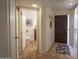 Home entryway with tile flooring leading to half bath and featuring stylish front door and closet space at 7755 E Thomas Rd # 17, Scottsdale, AZ 85251
