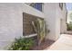 Exterior detail of the home featuring well-maintained stucco, a decorative cactus, and lovely landscaping at 7755 E Thomas Rd # 17, Scottsdale, AZ 85251