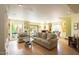 Open-concept living room with hardwood flooring, large windows, and a cozy seating arrangement at 7755 E Thomas Rd # 17, Scottsdale, AZ 85251