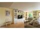 Bright living room featuring hardwood floors, custom built-ins, and a comfortable seating arrangement at 7755 E Thomas Rd # 17, Scottsdale, AZ 85251