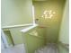 Carpeted staircase with decorative lighting fixtures and green walls, leading to the upper level of the home at 7755 E Thomas Rd # 17, Scottsdale, AZ 85251
